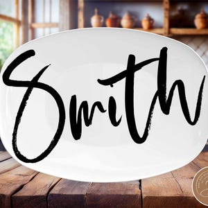 May include: White oval serving platter with the word "Smith" written in black brush script.