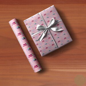 May include: Pink wrapping paper with a repeating pattern of colorful balloons and the text "Happy Birthday".