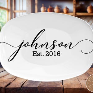 May include: White oval serving platter with black cursive text that reads "johnson Est. 2016".