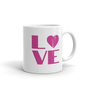 May include: White ceramic mug with a pink "LOVE" design. The "O" is replaced with a pink heart.