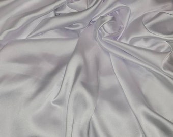 May include: White satin fabric with soft, flowing folds and a smooth, silky texture.