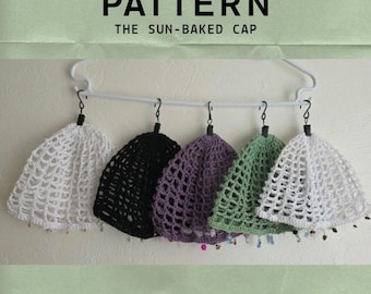 May include: Five crocheted caps in white, black, purple, green, and white, hanging from a white plastic hanger. Each cap features an open-work mesh design with small beads along the bottom edge. Text reads: PATTERN THE SUN-BAKED CAP @KRASACROCHET.