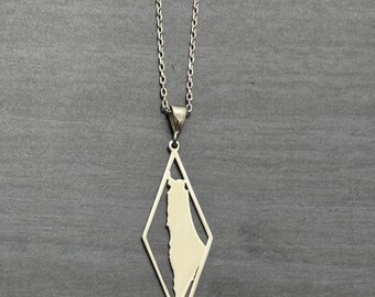 May include: A silver necklace with a pendant shaped like a diamond. The diamond has an outline of the country of Israel inside.