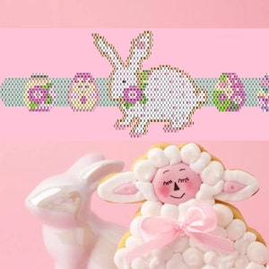 May include: A white ceramic bunny figurine with pink accents and a pink bow, a white ceramic egg, and a white sugar cookie decorated to look like a lamb with pink accents and a pink bow. The items are on a pink background.