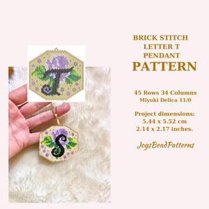 May include: A brick stitch beading pattern for a letter T pendant. The pattern is for a hexagonal pendant with a purple flower and green leaves. The pendant measures 2.14 inches by 2.17 inches. The pattern uses Miyuki Delica 11/0 beads.