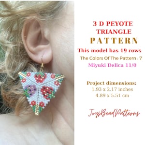 May include: A pair of white, red, green, and gold beaded earrings in the shape of a triangle. The earrings are made with Miyuki Delica 11/0 beads and are 1.93 inches by 2.17 inches.