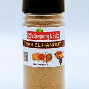 May include: A clear plastic spice jar with a black lid, labeled "Koli's Seasoning & Spice" and "RAS EL HANOUT." The label includes illustrations of spices and the text "A Taste of Africa." The net weight is 5 oz.