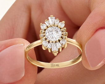 May include: A gold ring featuring a central round brilliant-cut diamond surrounded by a halo of smaller round and baguette-cut diamonds in a sunburst arrangement. The inner band is engraved with the text B14K.
