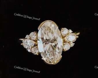 May include: A gold ring with an oval-shaped diamond and smaller diamonds on the band. The ring is in a black velvet ring box.