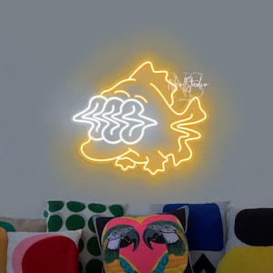 May include: A yellow neon sign shaped like a fish with white neon details. The sign is mounted on a grey wall above a light blue sofa with colourful throw pillows.