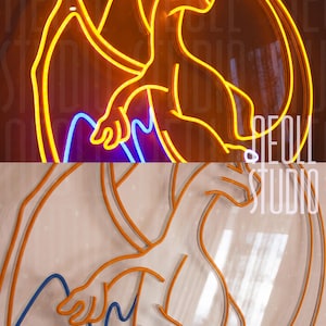 May include: A neon sign featuring a stylized dragon character in bright yellow, orange, and blue tubing. The sign is mounted on a clear acrylic backing and displays the text NEON STUDIO in white lettering on the right side of the design.