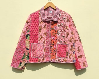 May include: A pink quilted jacket with a patchwork design featuring tigers, flowers, and geometric patterns. The jacket has a button closure and a collar.