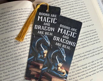 May include: Two black bookmarks with a dark blue dragon and a smaller dragon on a stack of books. The text on the bookmarks reads "Books are Magic and Dragon are Real".