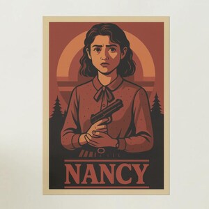 May include: Poster featuring a woman holding a handgun, with the name "NANCY" at the bottom. The artwork has a retro style with a color palette of red, orange, and black. The woman is wearing a red collared shirt.