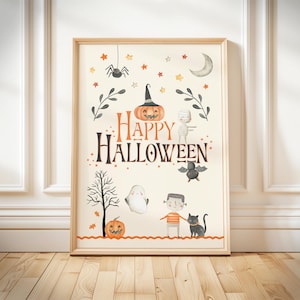 May include: A framed Halloween-themed print with a light beige background. The artwork features a jack-o'-lantern, a mummy, a ghost, a bat, and the words "Happy Halloween" in orange and black. The print is in a light brown wooden frame.