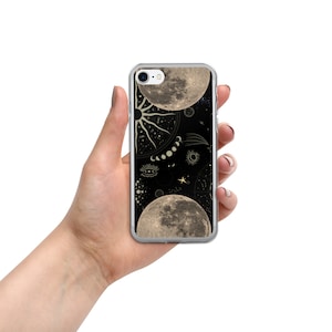 May include: A clear phone case with a black background and a celestial design featuring two moons, a sun, stars, and other celestial symbols.