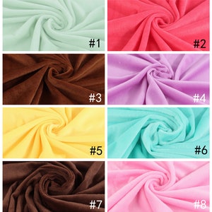 May include: Eight fabric swatches in different colors, including light green, red, brown, purple, yellow, light blue, dark brown, and pink. Each swatch is folded and arranged in a grid pattern. The swatches are numbered 1 through 8.