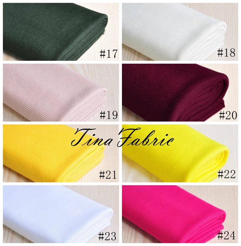 May include: A collection of ten fabric swatches in various colours, including green, white, pink, burgundy, yellow, and pink. Each swatch is rolled up and labelled with a number from 17 to 24.