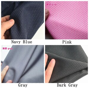 May include: Four fabric swatches in navy blue, pink, gray, and dark gray. Each swatch has a textured surface with small raised dots.