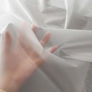 Tendance, ultra élégant, magnifique tissu transparent imperméable