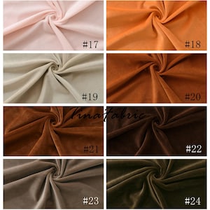 May include: A collection of eight fabric swatches in various shades of brown, beige, and pink. The swatches are arranged in a grid pattern and labeled with numbers 17 through 24.