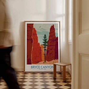 Bryce Canyon National Park art print framed on floor, man walking by in hallway.