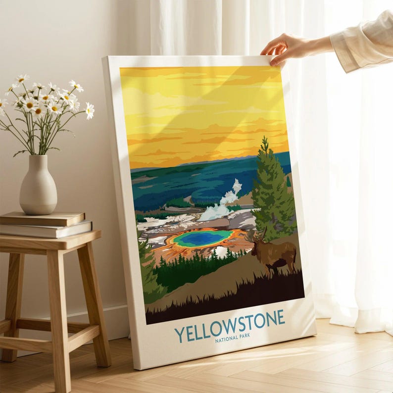 Hand holding Yellowstone National Park canvas print with colorful landscape in bright room