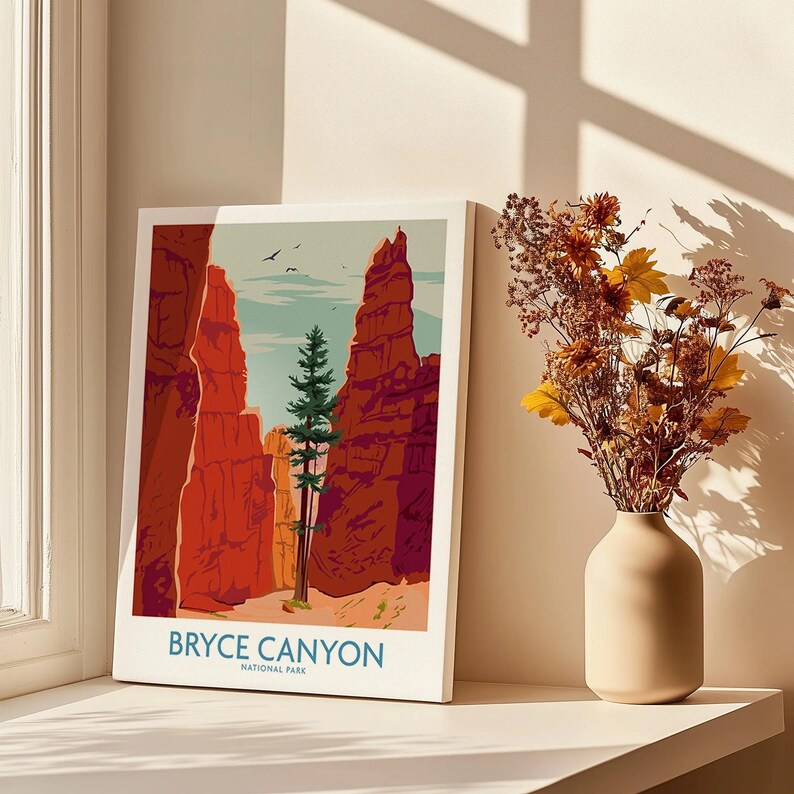 Bryce Canyon National Park art print on windowsill beside vase with dried flowers in sunlight