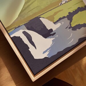 Framed travel poster art with mountain landscape, river, and off-road vehicle, perfect for home decor