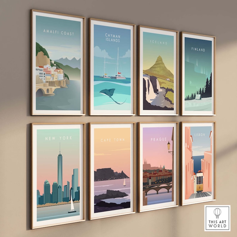 May include: A set of eight minimalist travel posters featuring iconic landmarks from around the world. The posters are framed in a light wood frame and are arranged in two rows of four. The posters feature destinations such as Amalfi Coast, Cayman Islands, Iceland, Finland, New York, Cape Town, Prague, and Lisbon.