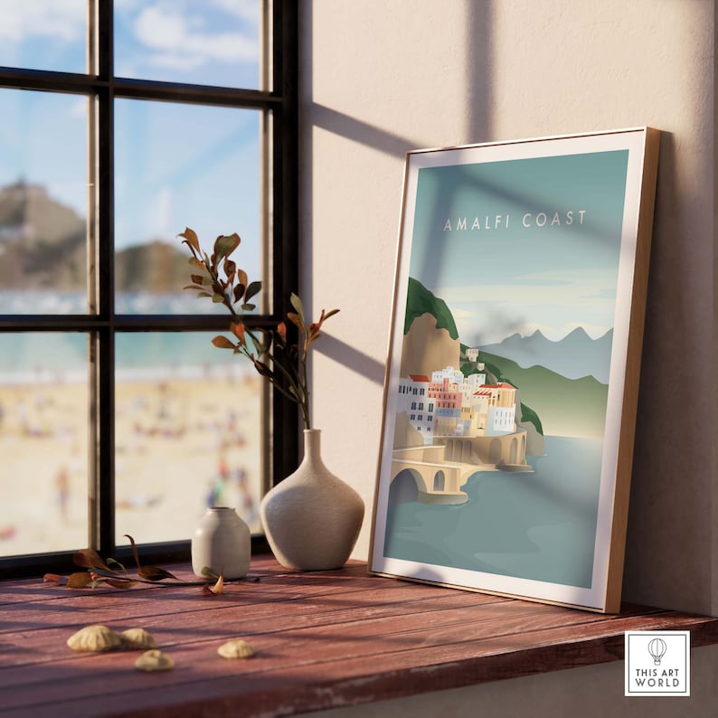 May include: A colorful illustration of the Amalfi Coast in Italy, with a blue sky, green hills, and a town with buildings and a bridge. The text "Amalfi Coast" is printed in white on a blue background.