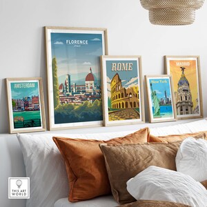 May include: Five framed travel posters with vintage-style illustrations of famous landmarks. The posters feature Amsterdam, Florence, Rome, New York City, and Madrid.