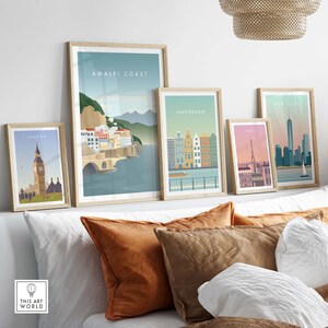 May include: Five framed illustrations of different cities around the world. The illustrations are in a minimalist style and feature iconic landmarks. The cities featured are London, Amalfi Coast, Amsterdam, Paris, and New York City.