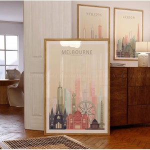 May include: A framed poster with a beige background featuring a skyline of Melbourne, Australia. The poster has the word "MELBOURNE" in large, bold letters at the top. The skyline includes the iconic Melbourne Star Observation Wheel and other buildings.
