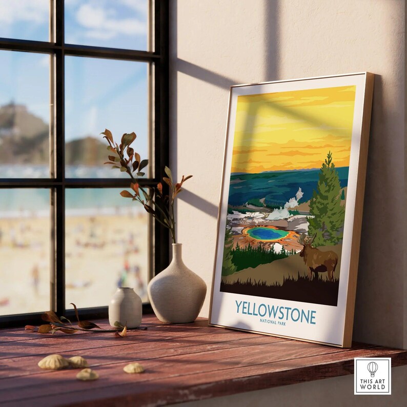 Framed Yellowstone National Park print with colorful landscape on a windowsill beside vases.
