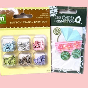 May include: Two packages of craft supplies. One package contains button brads in various colors, labeled "BUTTON BRADS BABY BOY". The other package is a card embellishment with a baby carriage design and the text "THE CARD CONNECTION".