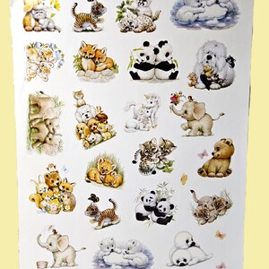 May include: A white sticker sheet featuring various colorful illustrations of baby animals including tigers, pandas, elephants, polar bears, and puppies. The sheet contains multiple groupings of animals in soft, detailed artistic styles.