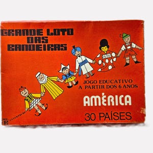 May include: A vintage orange box with the text "GRANDE LOTO DAS BANDEIRAS" and illustrations of children in traditional clothing. The box also includes the text "JOGO EDUCATIVO A PARTIR DOS 6 ANOS" and "AMÉRICA 30 PAÍSES".