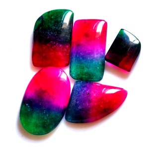 May include: Five polished gemstones with a layered, gradient color pattern. The stones are shades of green, purple, pink, and black.