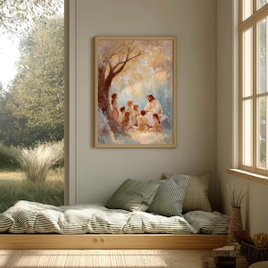 May include: A framed print depicting a religious scene. The artwork shows a figure in white robes teaching a group of children under a tree. The print is in a light wooden frame and hangs on a neutral-colored wall. The room has a window and a built-in daybed.