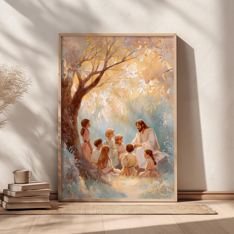 May include: A framed print depicts a religious scene with a man in white robes teaching a group of children under a tree. The artwork features soft colors, with a focus on the figures and the natural setting. The frame is a light wood color.