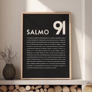 May include: Black and white framed wall art with the text "SALMO 91" in large white font. The artwork features a religious passage in Spanish. The frame is a light wood color.