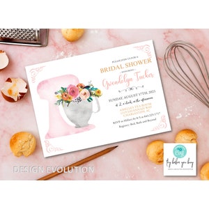 May include: A pink and white bridal shower invitation with a watercolor illustration of a stand mixer decorated with flowers. The invitation text reads "Please join us for a Bridal Shower honoring Gwendolyn Tucker, Sunday, August 17th, 2021 at 2 o'clock in the afternoon, Amelia's Tea Room, 1219 Savannah Way, Charleston, SC, RSVP to Hillary by 8/5 at 843.225.1717, Registry: Bed, Bath and Beyond."