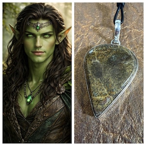May include: A green-skinned fantasy character with long brown hair, pointed ears, and a jeweled headpiece. Next to it is a teardrop-shaped pendant with a silver-colored frame and a brown and tan patterned stone, hanging from a black cord.