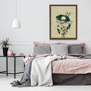 May include: A framed print of a botanical illustration featuring a pink lotus flower with green leaves on a beige background.