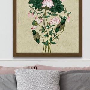 May include: A framed print of a watercolor painting of pink lotus flowers with green leaves on a beige background. The text "ROSES & CALLIGRAPHY" is in the upper left corner of the print.