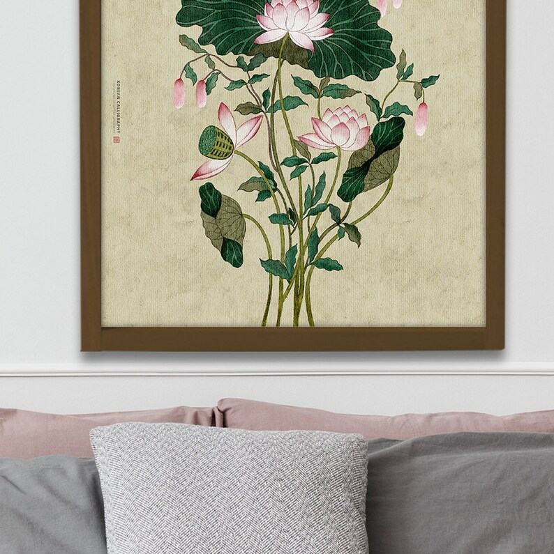 May include: A framed print of a watercolor painting of pink lotus flowers with green leaves on a beige background. The text "ROSES & CALLIGRAPHY" is in the upper left corner of the print.