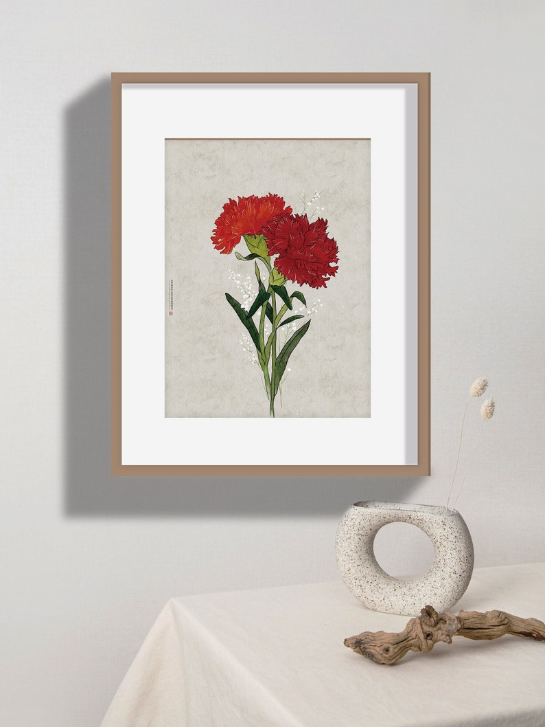 May include: A framed print of a botanical illustration featuring two red carnations with green stems and leaves against a light beige background.