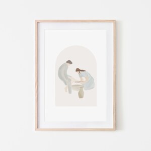 May include: A watercolor painting of two people in a soft blue and gray color scheme. The figures are in an arched doorway, with one person kneeling and washing the other's foot. A small, light brown pot sits between them.