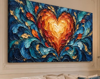 May include: A large rectangular canvas painting featuring a central heart shape rendered in thick, textured impasto brushstrokes. The heart displays warm shades of yellow, orange, and red, surrounded by deep blue and teal swirls with gold accents.